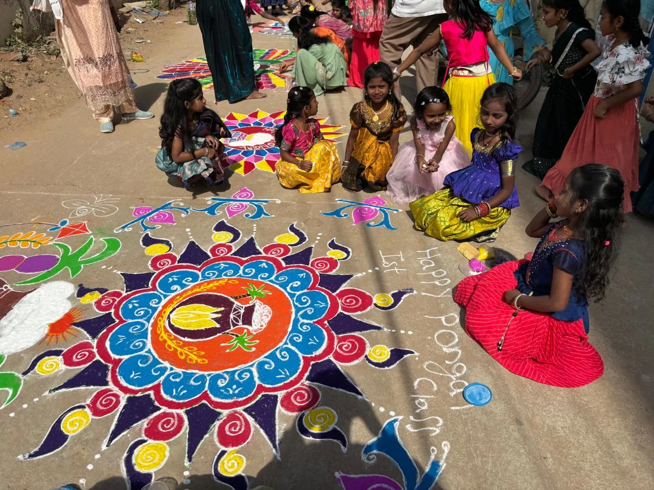 Children sitting around their Sankranti rangoli