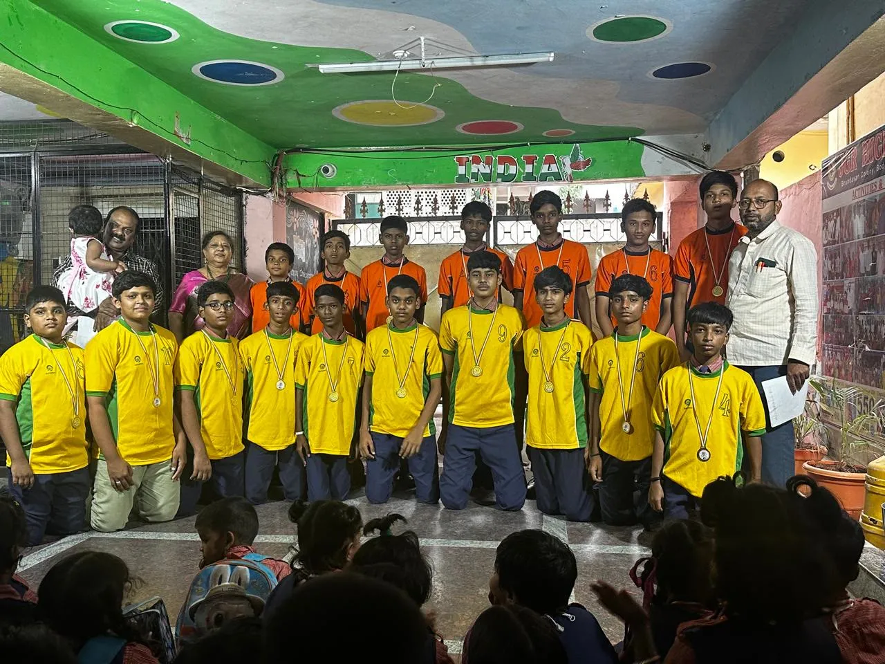 High-school students with medals and trophies from the Independence Day Sports Meet