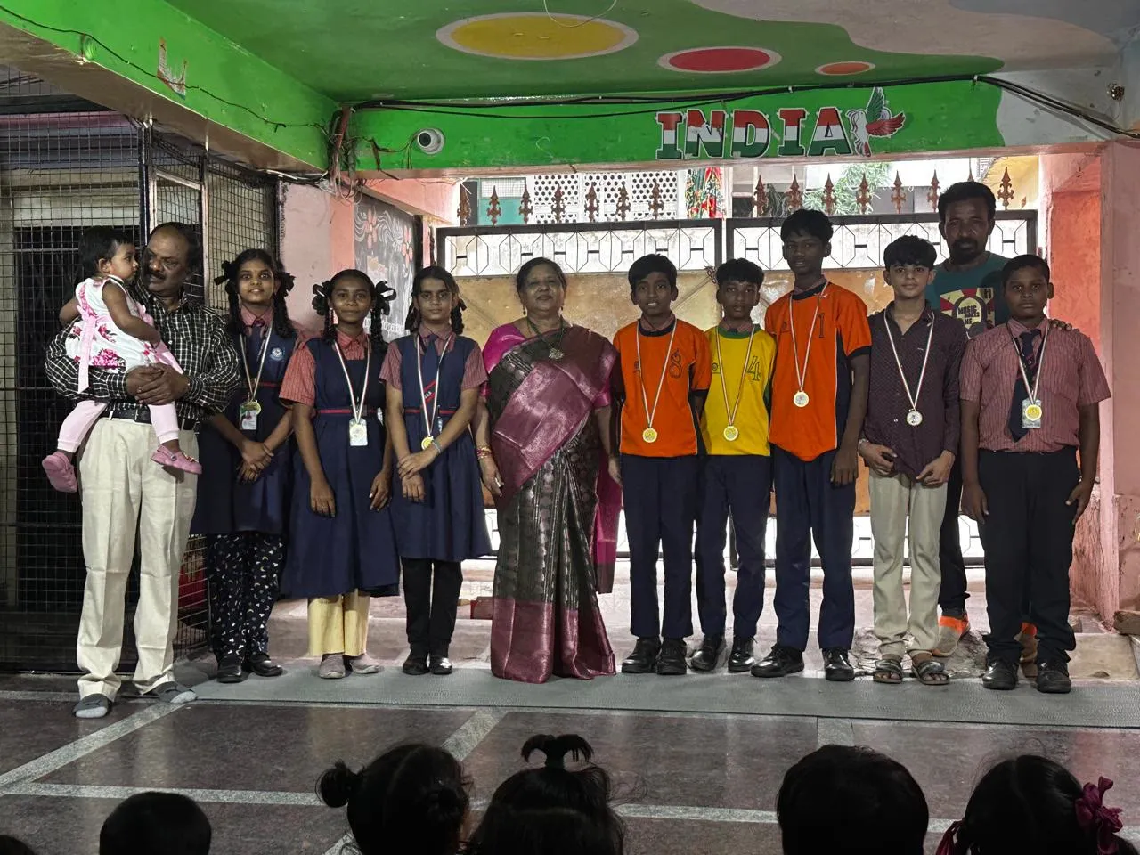 Students with their medals and teachers at school